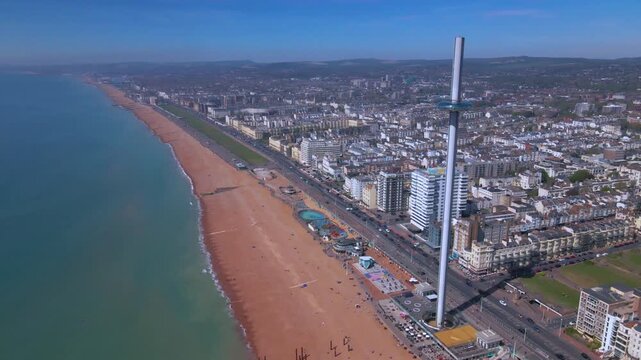 Modern observation tower i360 rising above Brighton beach and coastline
