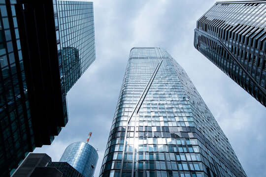 Skyscraper architecture tower glass skyline vertical clouds modern Bankenviertel Frankfurt financial district view with bright urban atmosphere