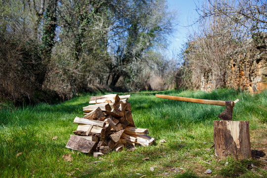 Pile of logs cut into splinters with a two-handed axe to be used as firewood for fireplaces