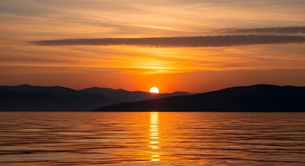 Obraz premium Breathtaking sunrise over mountain range and calm lake water