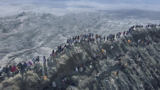 Crowds of tourists and locals at the edge of Mount Bromo crater, East Java, Indonesia.