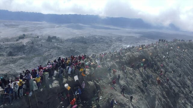 Crowds of tourists and locals at the edge of Mount Bromo crater, East Java, Indonesia.