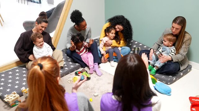 Diverse mothers and toddlers enjoying playgroup activities