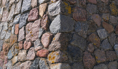 Fototapeta premium Close-up of an ancient stone wall corner texture