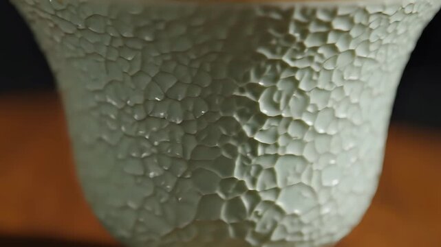 Closeup of a Celadon Crackle Glaze Ceramic Tea Cup.