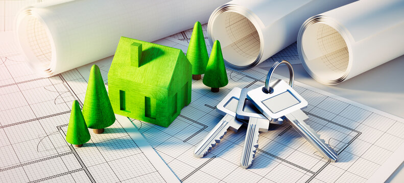 Keychain and keys with green symbol house, trees and architectural plans - concept of planning a home	