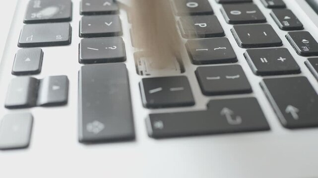 Macro video of electronic hardware maintenance showing careful cleaning of a keyboard button slot.