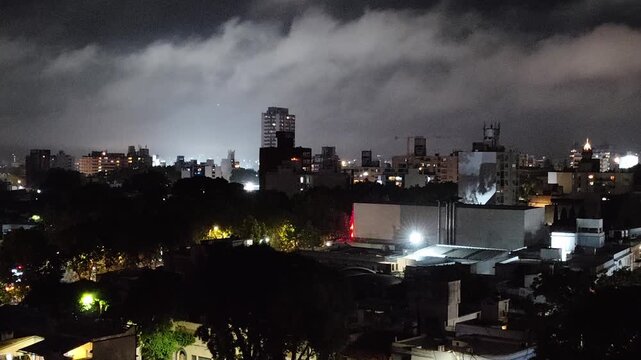 High contrast aerial view wide shot static video of montevideo city at night with overcast sky