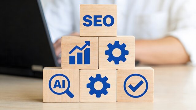 Wooden blocks with seo and business icons on a desk with a laptop