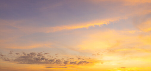 Fototapeta premium Beautiful sunset sky background with vibrant orange, pink, and blue colors,Breathtaking panoramic view of a dramatic sunset sky, featuring a stunning gradient of deep blue to fiery orange and soft.
