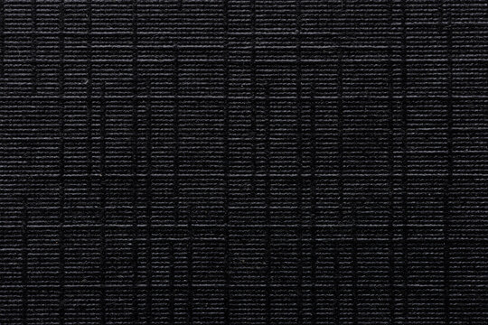 Black ripstop fabric texture background. High detailed macro shot of durable synthetic material,Macro,Top view of black waterproof ripstop nylon fabric with a characteristic grid pattern. Technical.