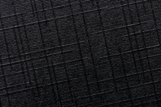 Black ripstop fabric texture background. High detailed macro shot of durable synthetic material,Macro,Top view of black waterproof ripstop nylon fabric with a characteristic grid pattern. Technical.