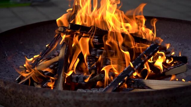 Slow motion of intense fire flames burning wood in a fire pit. Recorded in AppleProRes 422 for maximum editing flexibility.