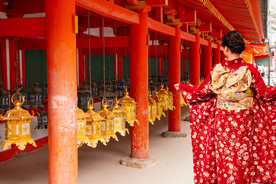 Japanese woman wearing japanese traditional kimono - Kasuga taisha shrine temple bronze lanterns - Nara, Japan