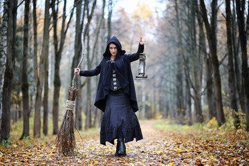Naklejka premium A woman in a witch suit in a forest