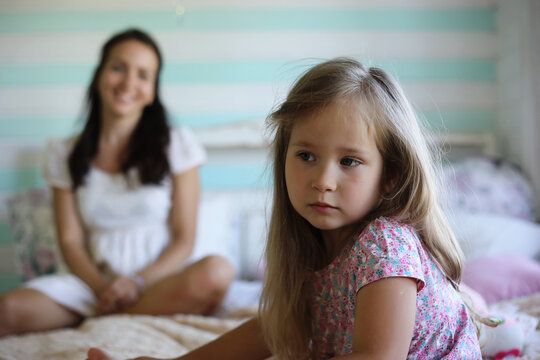 Morning idleness. Mom and daughter have fun.