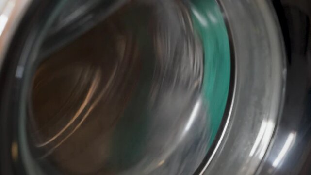 spinning washing machine drum detail, fast rotation background for laundry service and cleaning workflow concept