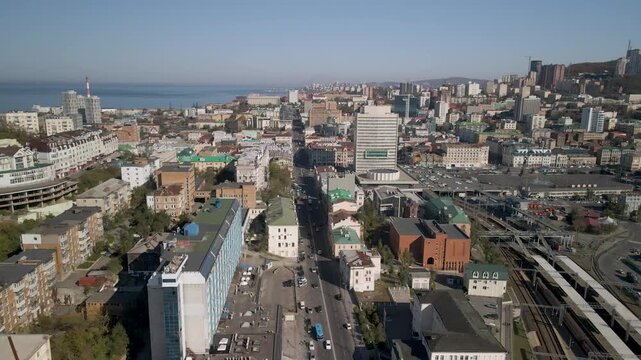 Drone hovering over Vladivostok center showing the White House, main Square, the railway, and the sea.