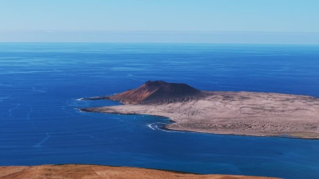 Atlantic ocean view, La Graciosa island and Monta&ntilde;a Amarilla volcano from Mirador del R&iacute;o viewpoint in Lanzarote, Spain. Aerial drone panoramic view, copy space