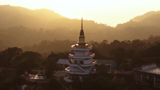 Golden top pagoda at Wat Teepangkorn during sunset