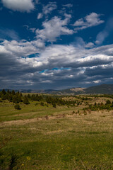 Fototapeta premium Vertical image, scenic view from the Carpathian mountains, blue sky with white clouds.