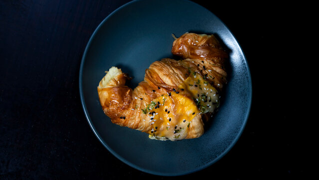 butter croisan with cream topping on plate	