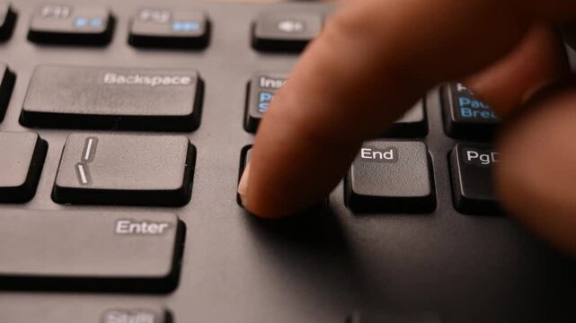 Close Up of Keyboard with Man Using Delete Key to Clear Selected Data