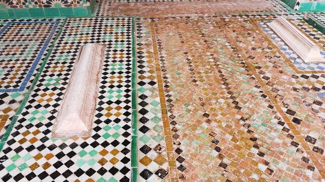 Traditional moroccan architecture with ancient graves decorated in colorful zellij mosaic tiles. Beautiful geometric patterns on the walls of the historic Saadian tombs in Marrakesh. 