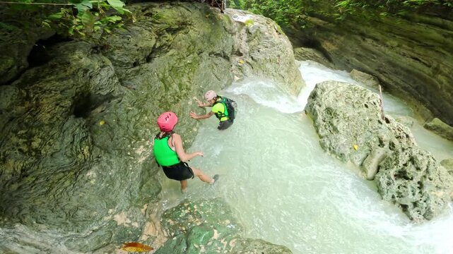 Tourists navigate canyon pool Kawasan Falls Badian Cebu Philippines travel