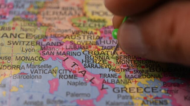 World Map Shot Featuring Green Pin Highlighting Bosnia and Herzegovina Pointed by Hand 4K 60fps
