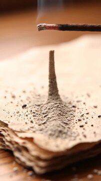 Cigarette butt on ashtray with scattered ash close up