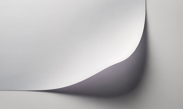 A single sheet of paper with a curled corner creating a soft shadow and smooth curve