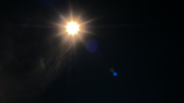 Bright star shines bold against velvet night sky. Lens flare glows with warm, radiant light. Darkness frames star's brilliance, pure and clear. Perfect for cinematic night scenes or cosmic themes