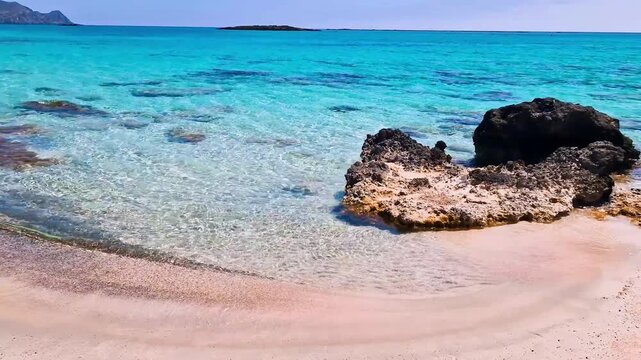 Greece Crete 4K Video of Elafonisi Beach with Pink Sand and Turquoise Transparent Sea No People Exotic Tropical Landscape with Black Rocks and Gentle Waves sound