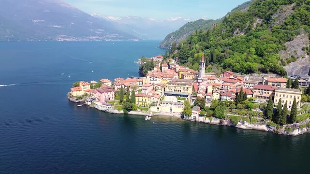 Aerial drone view of Varenna colorful houses on Lake Como coastline, scenic Italian village by water, travel destination Italy