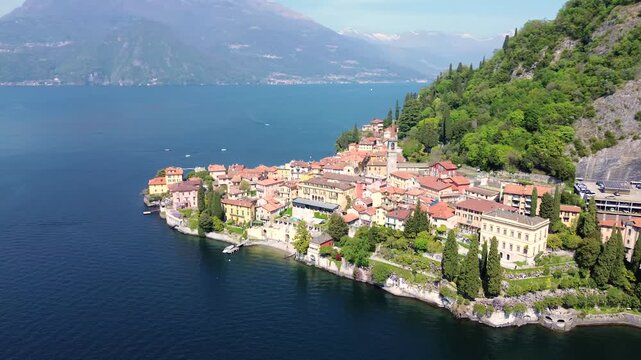 Aerial drone view of Varenna colorful houses on Lake Como coastline, scenic Italian village by water, travel destination Italy