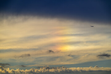 Naklejka premium A beautiful sundog or parhelion phenomenon appearing in the clouds above Tamsui Bridge in New Taipei City, Taiwan, during a summer sunset.