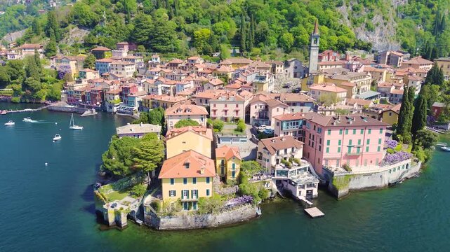 Aerial drone view of Varenna colorful houses on Lake Como coastline, scenic Italian village by water, travel destination Italy