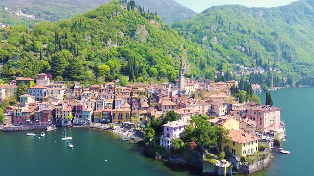 Aerial drone view of Varenna colorful houses on Lake Como coastline, scenic Italian village by water, travel destination Italy