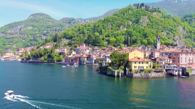 Aerial drone view of Varenna colorful houses on Lake Como coastline, scenic Italian village by water, travel destination Italy