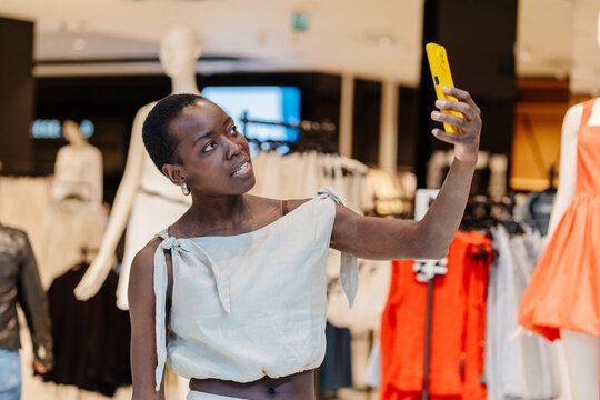 African American Fashion Blogger Capturing Content in Retail Space