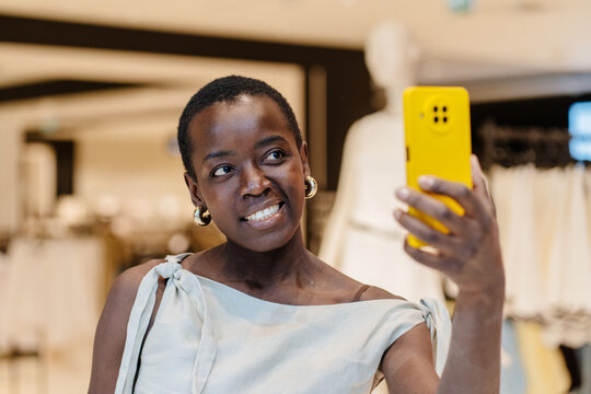 Close Up Portrait of Smiling Black Woman Taking Selfie in Shop