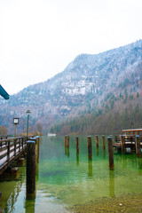 Fototapeta premium Königssee with snowy mountain and wooden pier