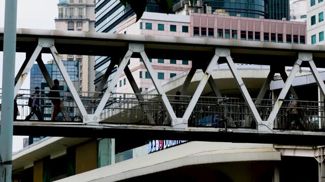 busyness at a bridge crossing on Jalan Sudirman, Jakarta, Indonesia in the morning
