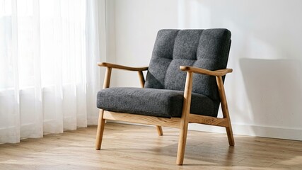 Fototapeta premium Modern armchair with wooden frame and quilted upholstery in a bright, minimalist room with sheer curtains and wooden floor.