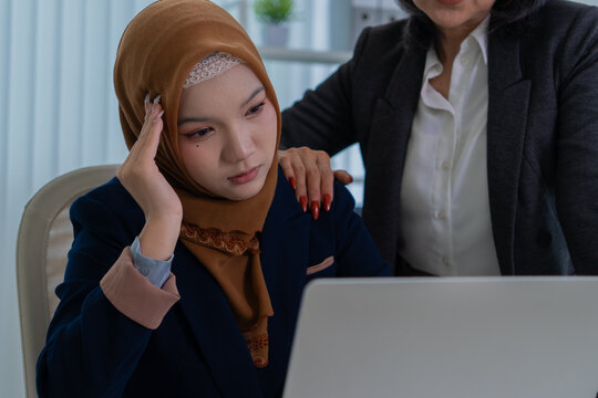 Muslim female applicant consulting with hiring manager in modern