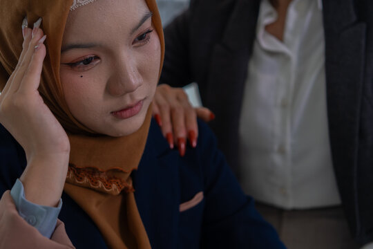 Muslim female applicant consulting with hiring manager in modern