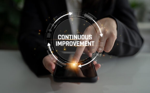 Person in business attire using smartphone to navigate digital symbol of continuous improvement with glowing circular graphics and modern technology backdrop Sigmoid