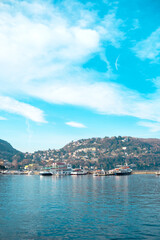 Fototapeta premium Lake Como water and hillside town with boats