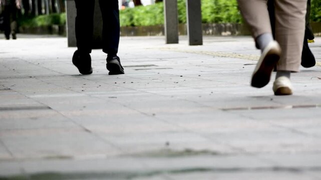 Feet walking along the sidewalk of Jalan Sudirman, Jakarta, Indonesia 03

